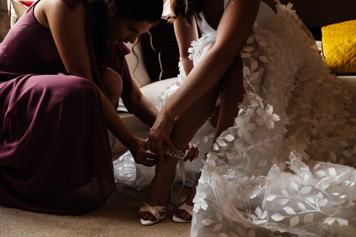 wedding dress bridesmaids helping with dress Wyresdale park wedding Photography