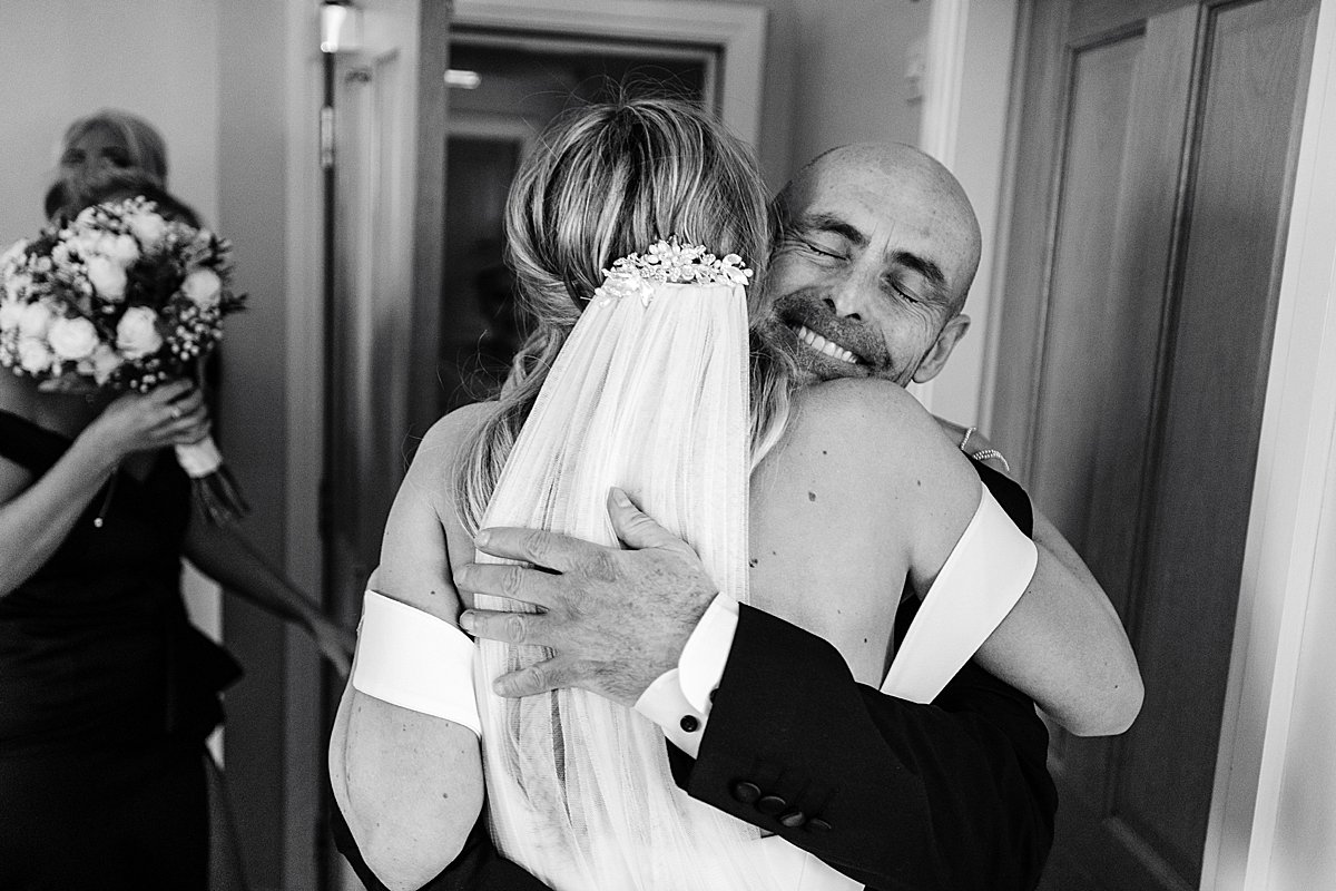 bride hugs dad , family love smiles wedding day photography the villa wrea green