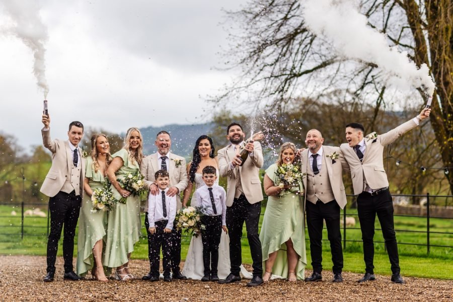 champagne celebration with bride and groom and family browsholme hall weddings