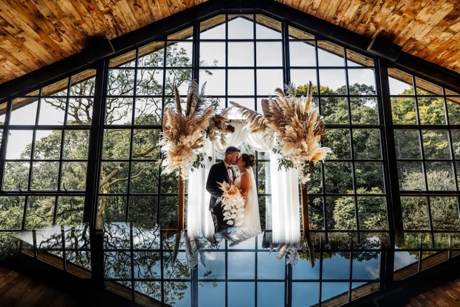 hidden river barn wedding venue bride groom window