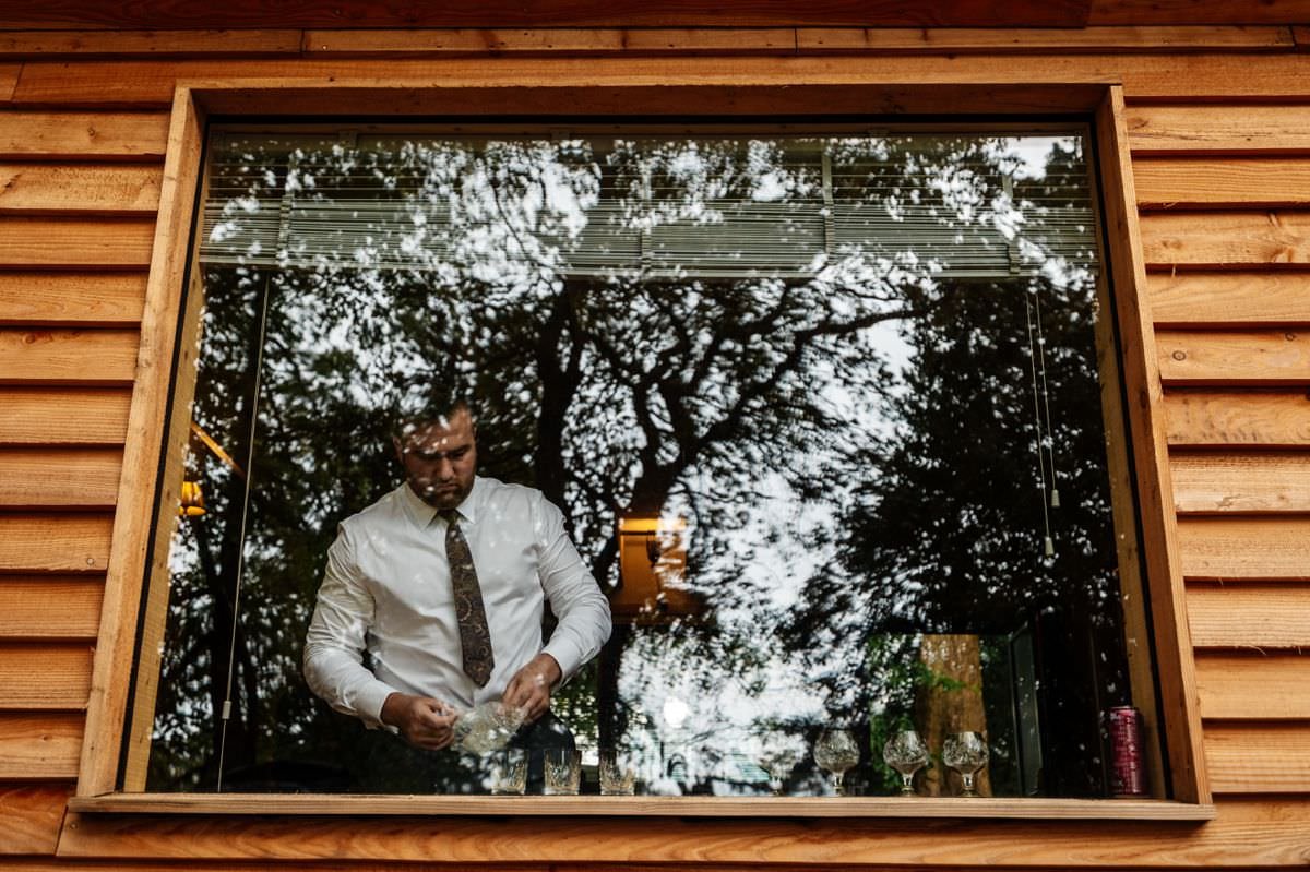 groom in window getting ready wyresdale park wedding photography 