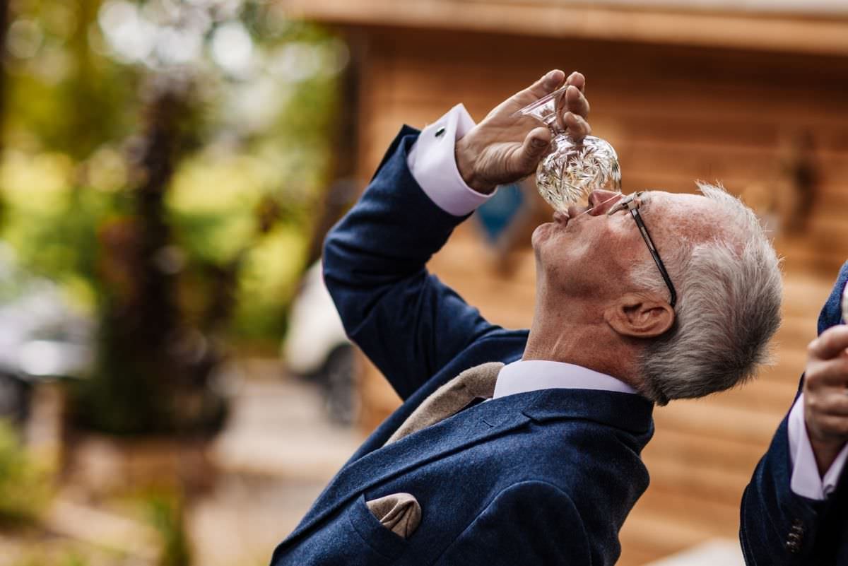 grooms dad having a drink of whisky at wyresdale park lodges