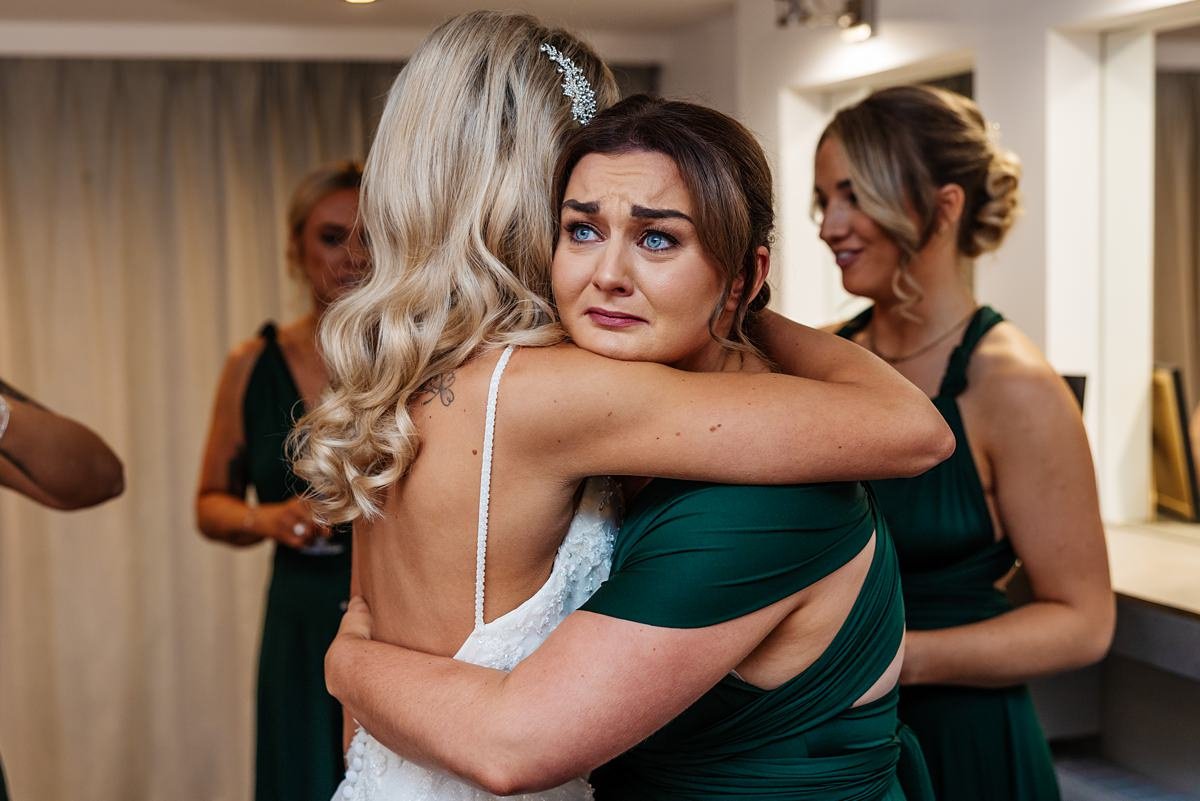 bridemsaid crying hugging bride bashall barn wedding photography