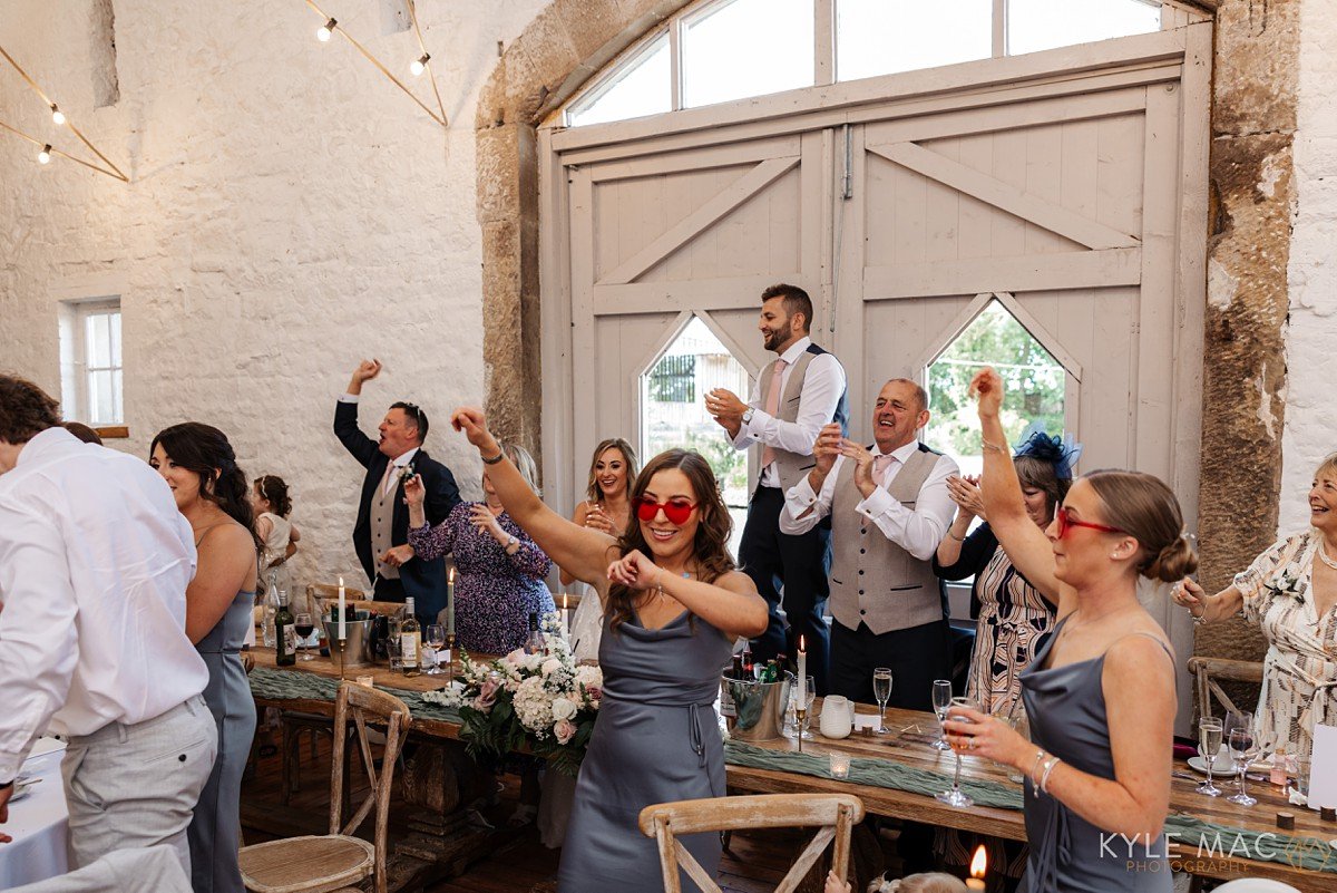 wedding guests party dancing on chairs wyresdale park