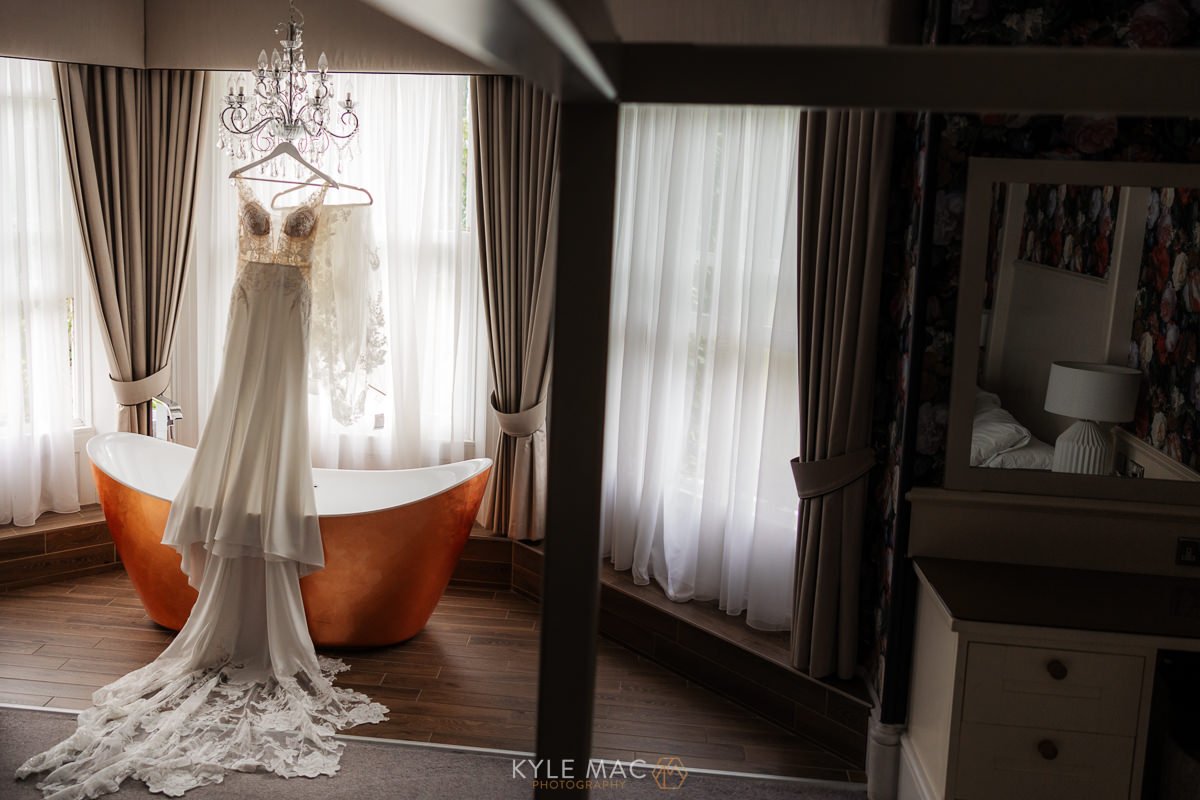 bartle hall wedding dress hanging over bath