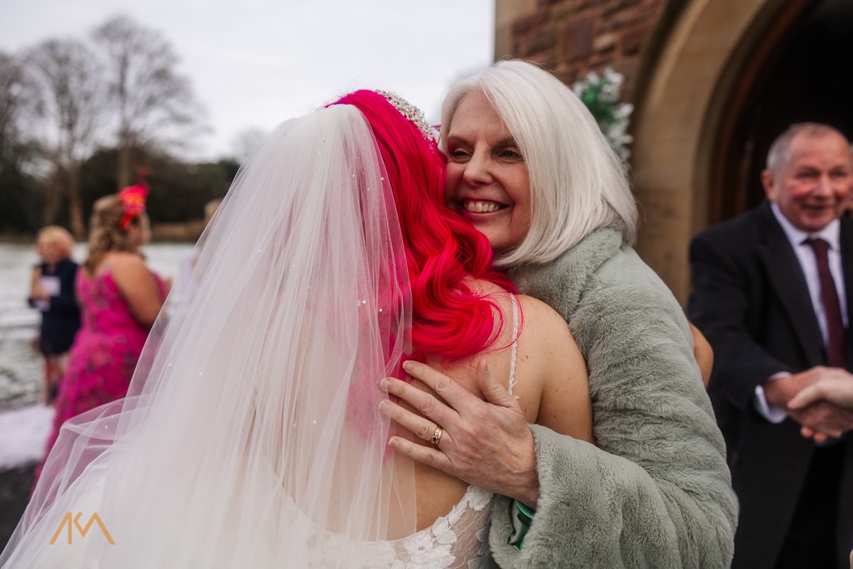 hugs wedding guests snow winter wedding