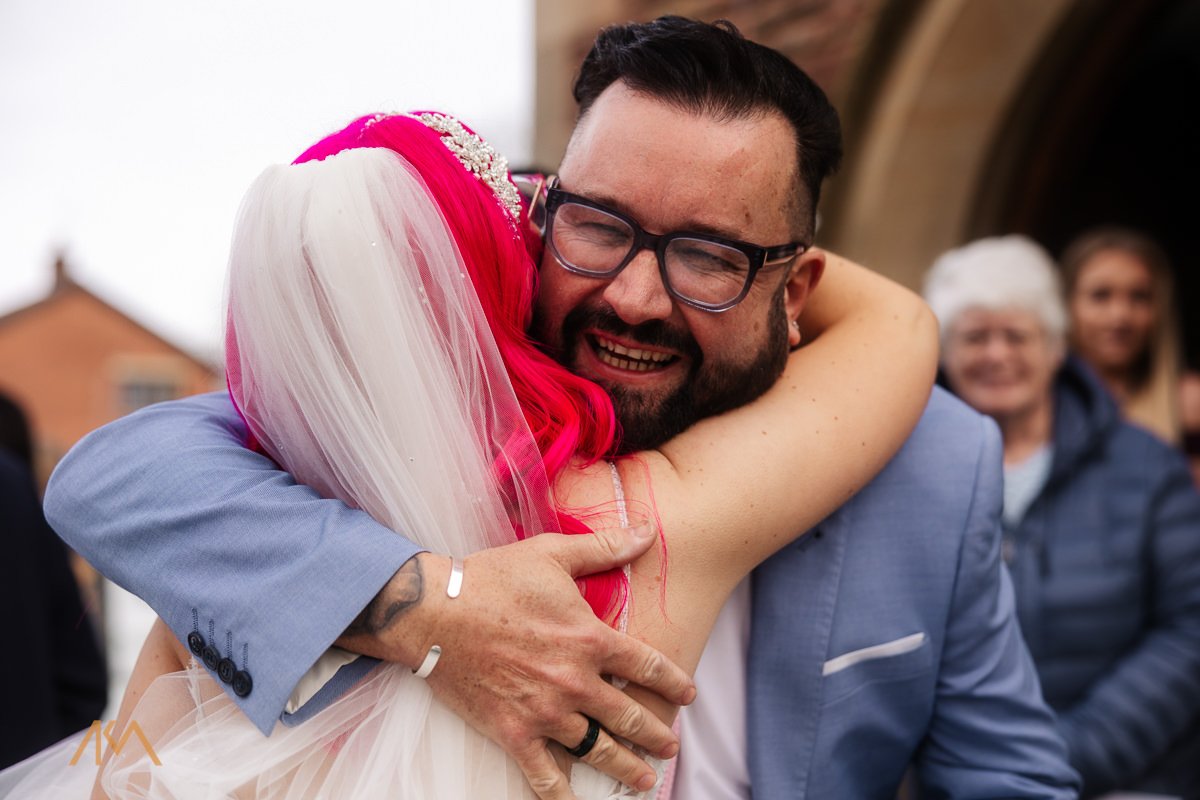 hugs from guests winter church wedding chorley