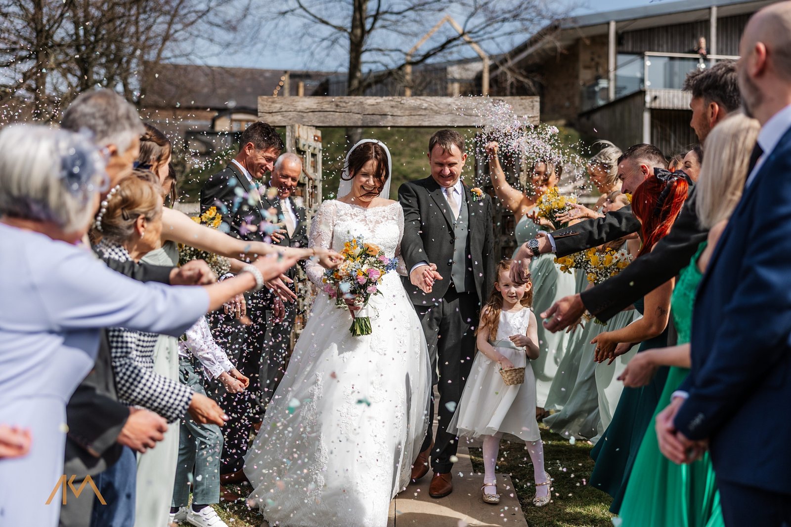 spring confetti outside bashall barn family friends smiles