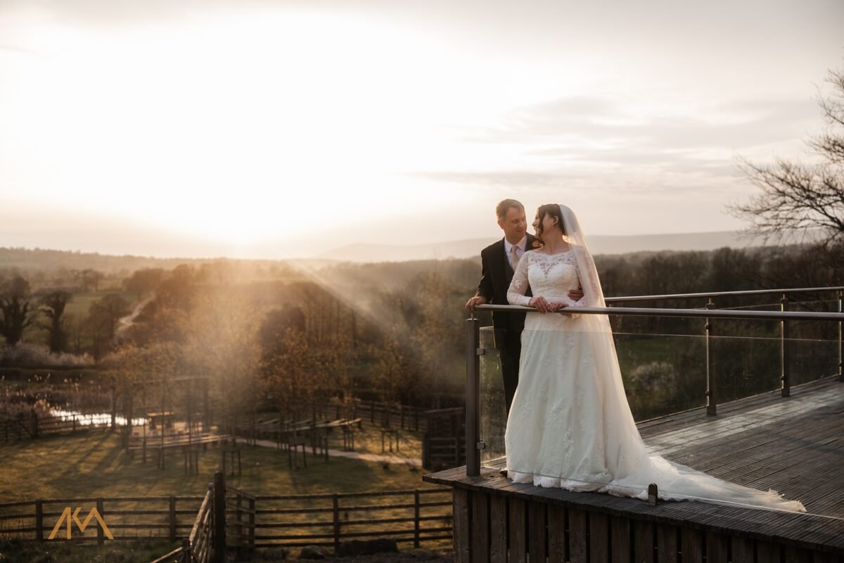 sunset over the ribble valley bashall barn wedding bride groom hugging