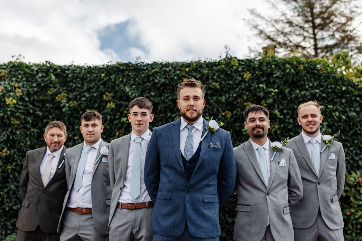 groomsmen wedding venue flowers suits the river barn