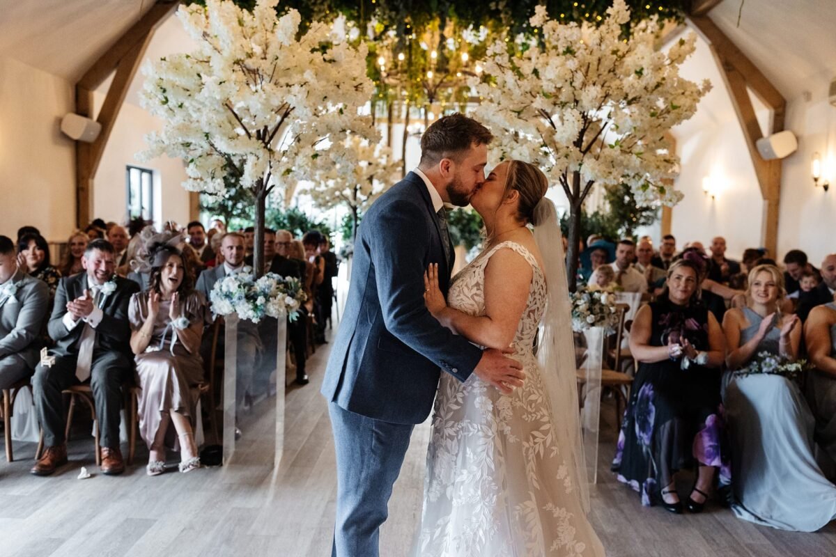 bride groom kissing river barn wedding venue