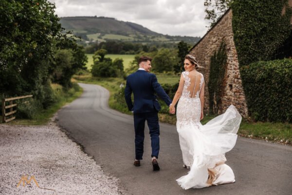 bashall barn wedding venue countryside photography bride groom walking