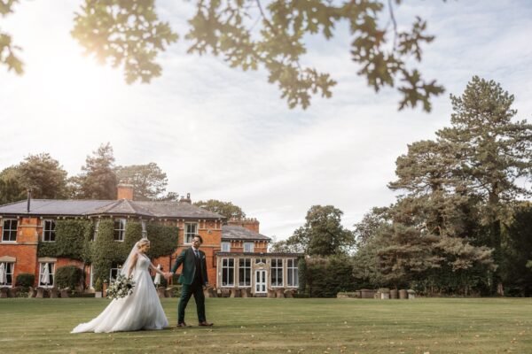 Bartle Hall Summer Wedding venue bride groom walking under the clouds