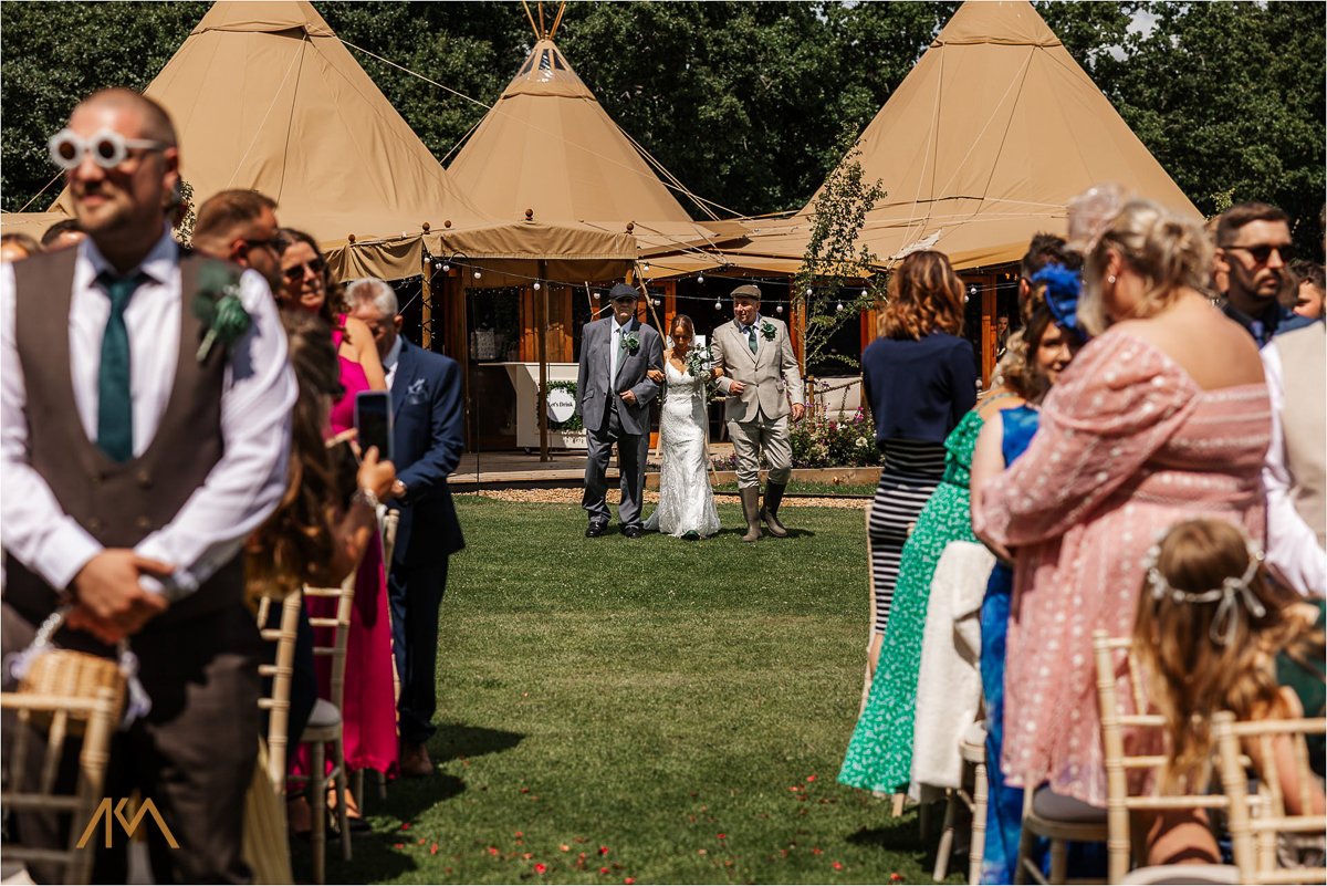 Tipis at Riley Green outdoor ceremony summer wedding
