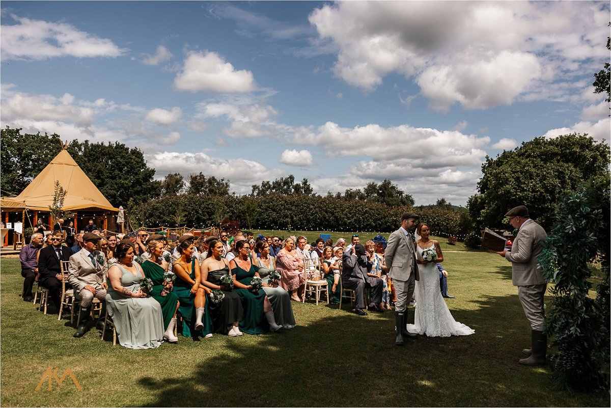 Tipis at Riley Green summer wedding outside ceremony