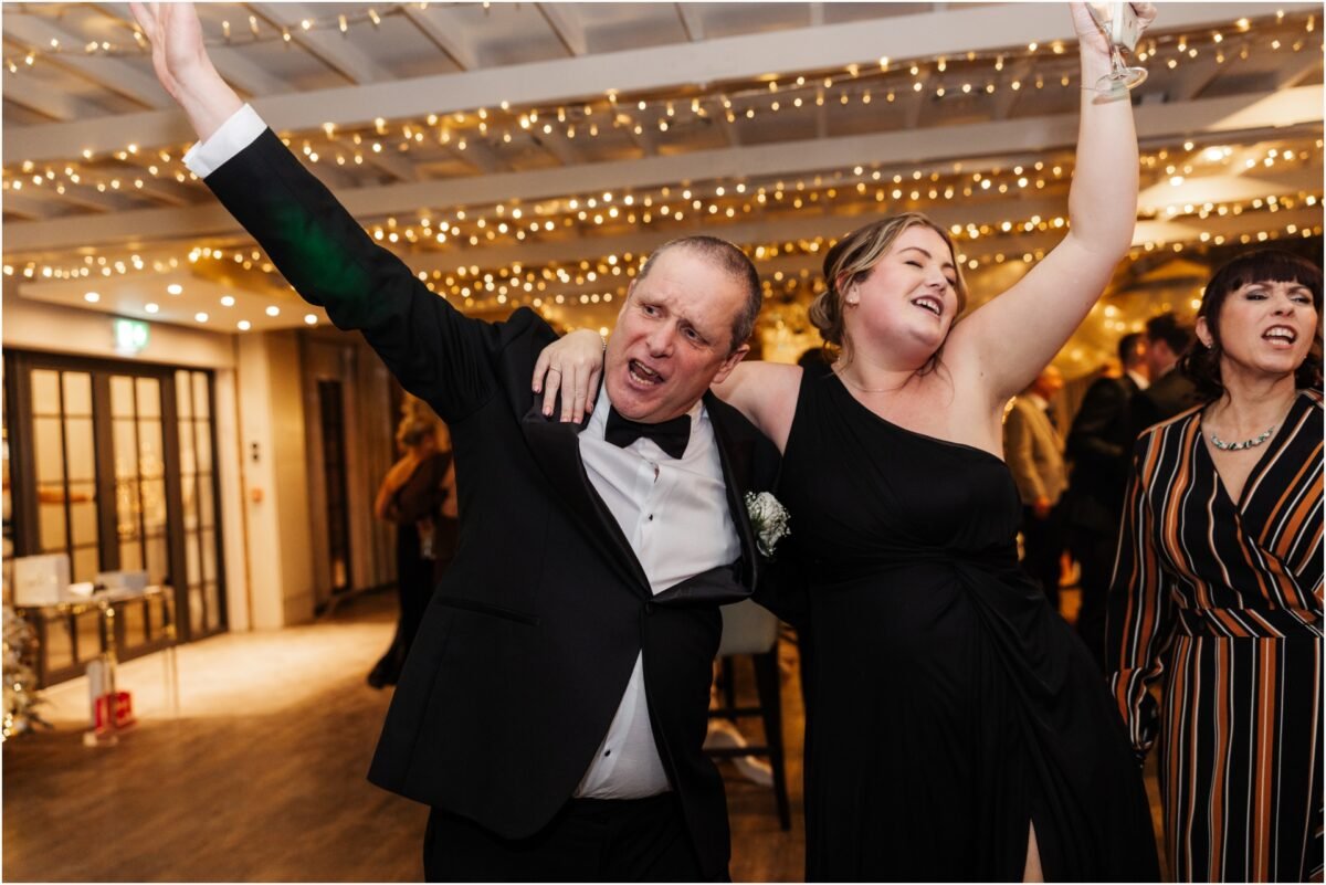 brides dad celerbrating with wedding guests bartle hall barn winter 