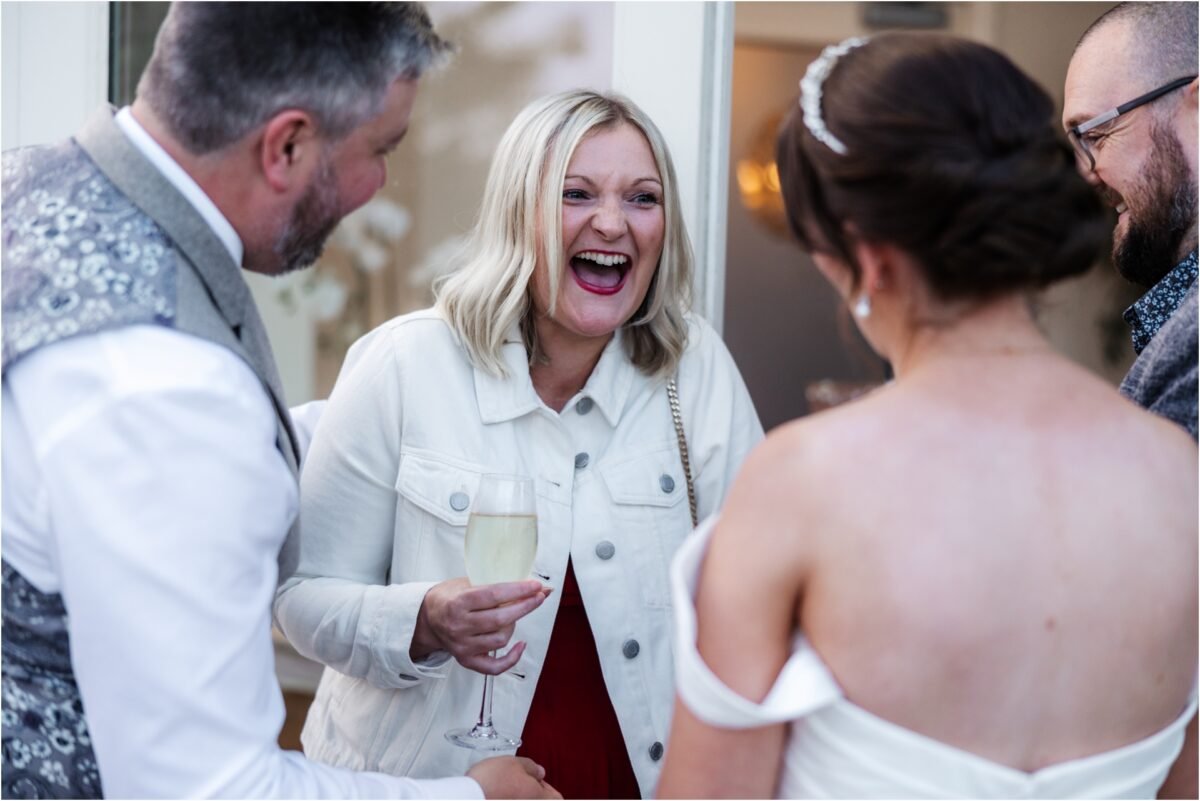 wedding guests laghing with friends shireburn arms