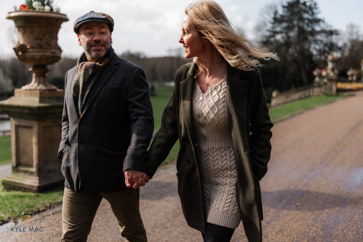 smiles couple walking engagement photography park wedding