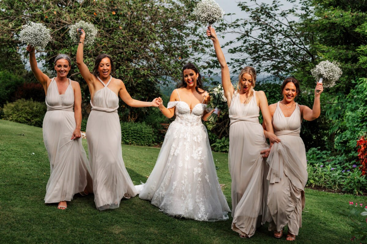 bridesmaids smiles flowers in the air bride shireburn arms ribble valley wedding