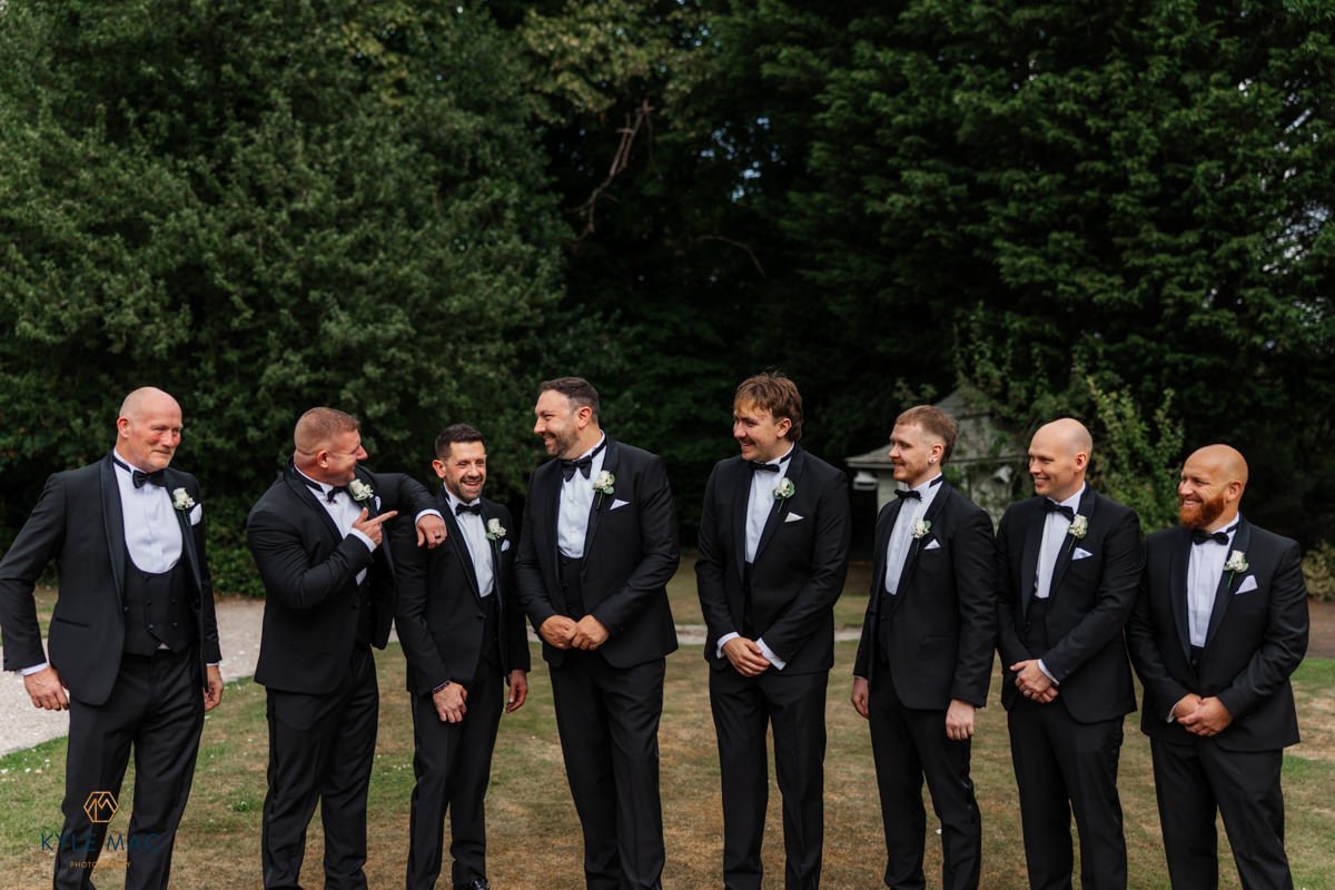 groomsmen black and white suits flowers bartle hall gardens