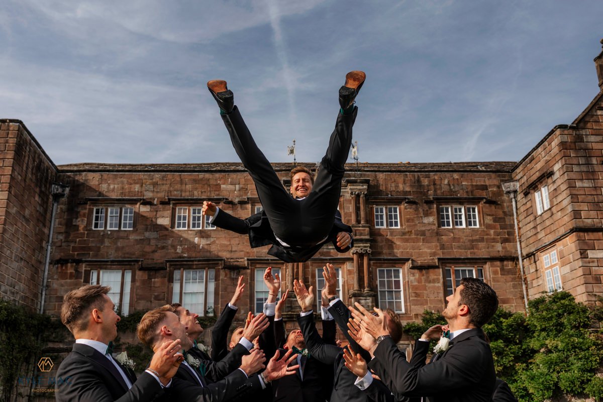 Groom thrown in the air by his friends at Browsholme Hall wedding