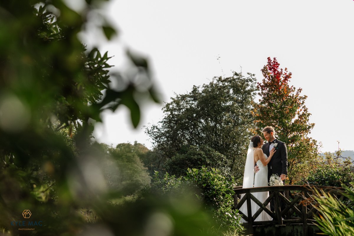 Groom kissing the bride in front of Browsholme Hall