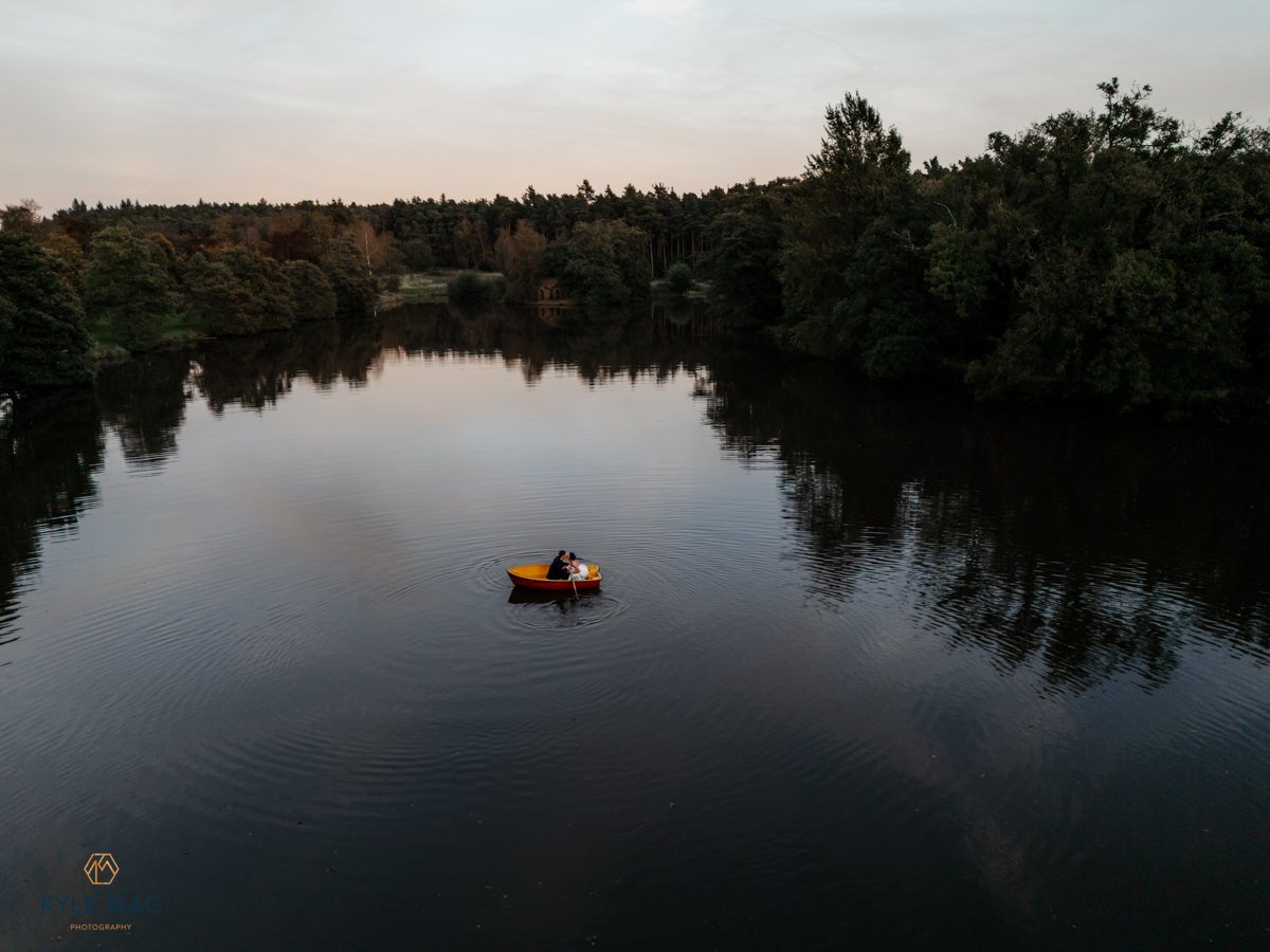 Drone wedding photography at Browsholme Hall, couple beside the lake