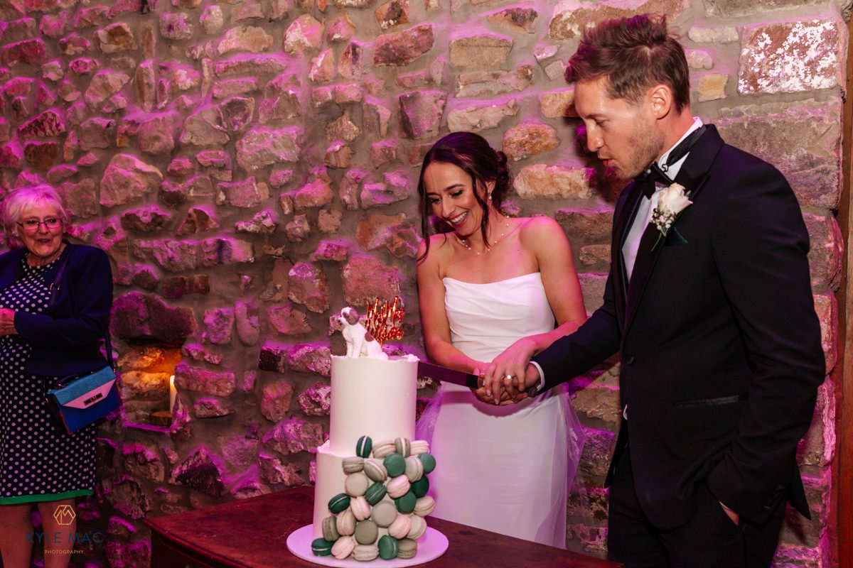 Couple laughing as they cut the cake, Ribble Valley wedding photographer