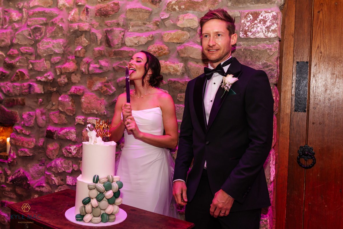 Bride and groom cutting the wedding cake at Browsholme Hall